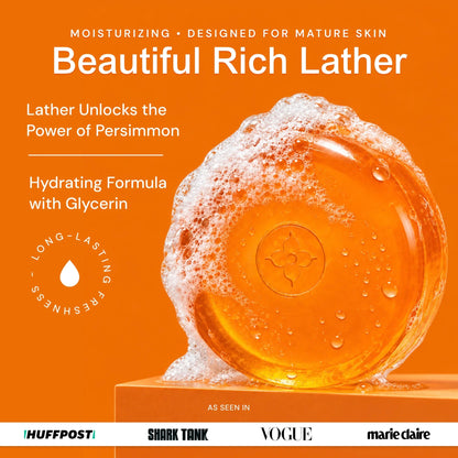 Unscented - An orange promotional graphic for 'Beautiful Rich Lather' moisturizing formula. The design features a large, translucent orange bar of soap with white lather foam on top, set against a solid orange background with white text detailing its benefits for mature skin and persimmon hydration.